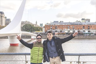Two happy tourists posing in Puerto Madero