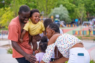 African black ethnic family with children in playground