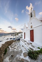 White Cycladic Greek Orthodox Twin Churches of Agios Antonios and Agios Nikolaos at sunrise