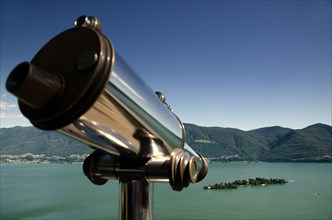 Telescope and Mountain over Alpine Lake Maggiore with Clear Sky in Brissago Islands in Ticino