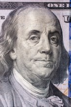 Close up of Benjamin Franklin face on 100 US dollar bill