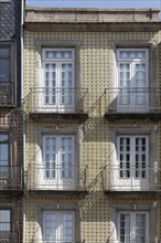 House facade tiled with azulejos and with iron balconies