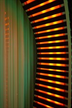 Illuminated Orange Stripes on a Modern Column in Switzerland