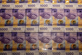 Illuminating Many 1000 Swiss Franc Banknote on Table in Switzerland
