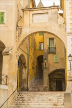 Narrow Street and with Aryh and Staircase in Old Town in Menton