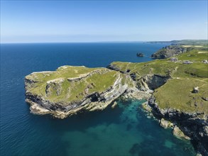 Aerial view of the rugged coastline on the Celtic Sea with the Tintagel Peninsula and the ruins of Tintagel Castle