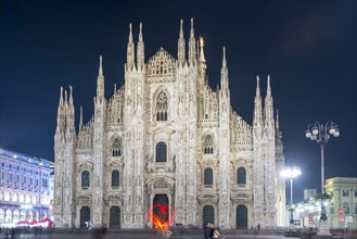 Person Light Painting a Heart Shape in Front of the Cathedral in City of Milan