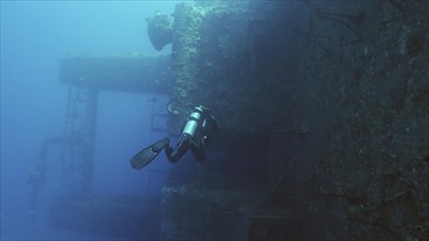 Scuba diver swim along deck of ferry Salem Express shipwreck