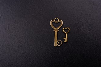 Heart shaped retro metal keys on dark background