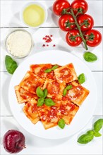 Ravioli Italian pasta eat lunch dish with plate in tomato sauce from top on wooden board in Stuttgart