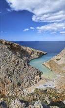 Vertical view of z-shaped lagoon or bay in typical summer Greek or Cretan landscape on sunny day. Great blue sky and beautiful clouds. Seitan Limania