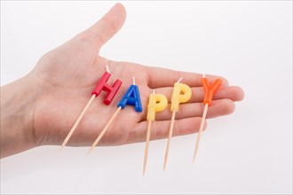 Color candles on sticks write the word happy