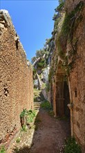 Walkway in ruins of remote abandoned Katholiko monastery in Avlaki gorge of Akrotiri peninsula