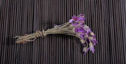 Bunch of flowers are placed on a straw mat