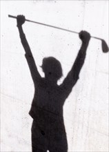 Shadow of a Golfer on a Wall Holding a Golf Club