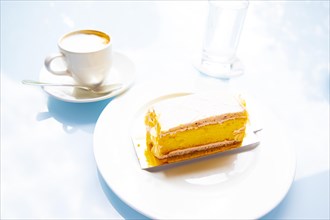 Lemon Cake and Cappuccino Coffee and Glass of Water