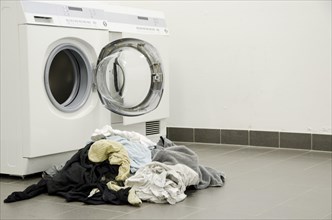 Dirty Clothes Lying Outside the Washing Machine