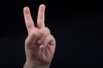 The sign of victory and peace in black background