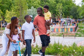 Black African ethnicity family with children at playground