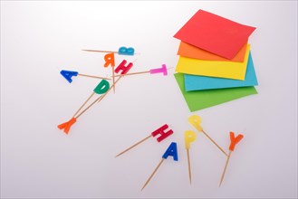 Colored envelopes and Color candles on sticks write happy