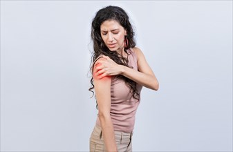 Woman with shoulder and arm pain on isolated background. Sore young woman with arm pain isolated. Woman suffering with arm pain