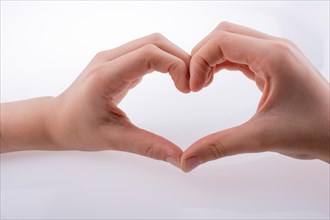 Hand making a heart shape on a white background