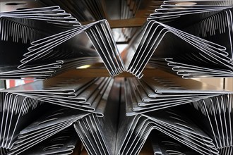 Folded metal sheets lying in front of a construction site