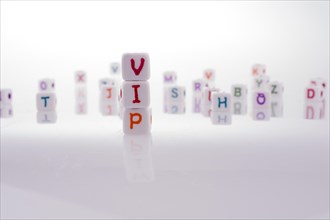 Alphabet blocks and the word VIP on a white background