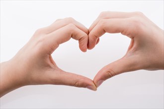 Hand making a heart shape on a white background