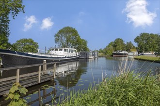 Boats anchored on the bank of a canal