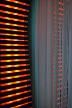 Illuminated Orange Stripes on a Modern Column in Switzerland
