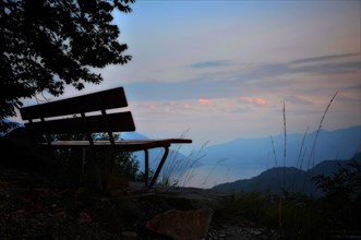 Bench with panorama view over an alpine lake Lago Maggiore