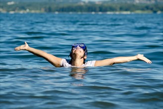 Woman with Diving Mask in the Water andArms Outstretched