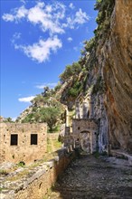 Ruins of entrance gate to abandoned Orthodox Katholiko monastery in Avlaki gorge
