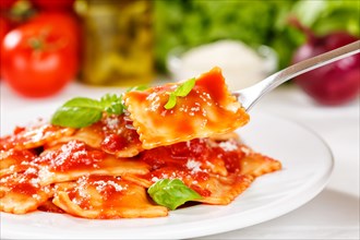 Ravioli Italian pasta in tomato sauce eat with fork lunch dish on plate in Stuttgart