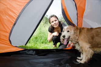 Woman Looking Inside a Tent with Her Cute Cocker Spaniel Dog in Switzerland