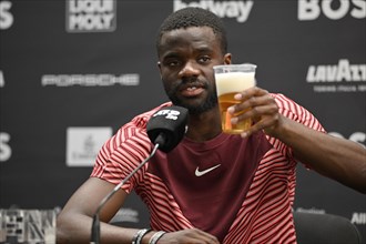Frances Tiafoe USA with German beer during the press conference