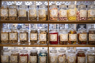 Sweets sorted in glass containers and placed on a shelf
