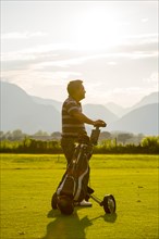 Golfer with his golf bag on the fairway