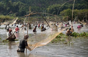 Villagers participate in a community fishing event on the occasion of Bhogali Bihu Festival at Goroimari Lake in Panbari village