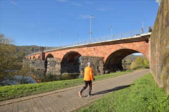 Historic UNESCO Roman Bridge over the Moselle with jogger