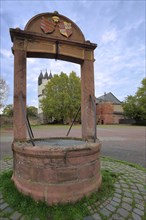 Castle courtyard fountain with coat of arms at the castle