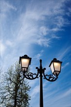 Old street lamp against a blue sky