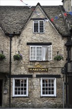 Old stone house with pub in the old town of Cirencester