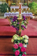 Peace candle and altar with floral decoration