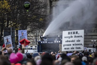Police officers act with water cannons against demonstrators protesting against the reform of the infection protection law in Berlin