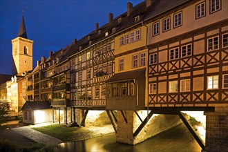 Half-timbered houses of the Kraemerbruecke with the river Gera and the Aegidienkirche in the evening