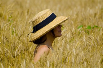 Woman with a Straw Hat in the Wheat Field