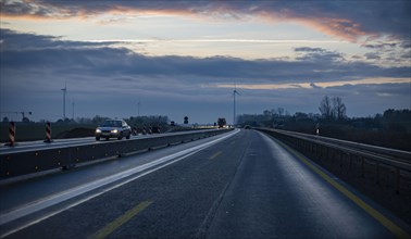 Cars drive along the A 10 motorway in Berlin at dawn. Berlin