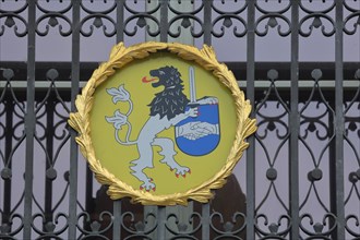 Town coat of arms and metal grille on the town hall